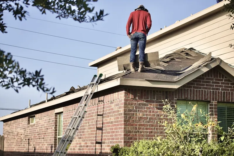Professional roofer working on a residential roof in Blairstown